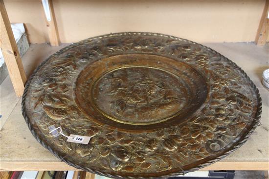 A large gilt brass embossed circular wall plaque